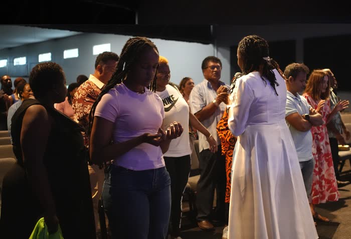 Dr. Imaobong Odutola praying with believers