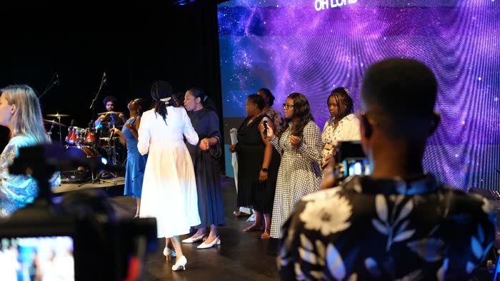 Dr. Imaobong Odutola praying with believers