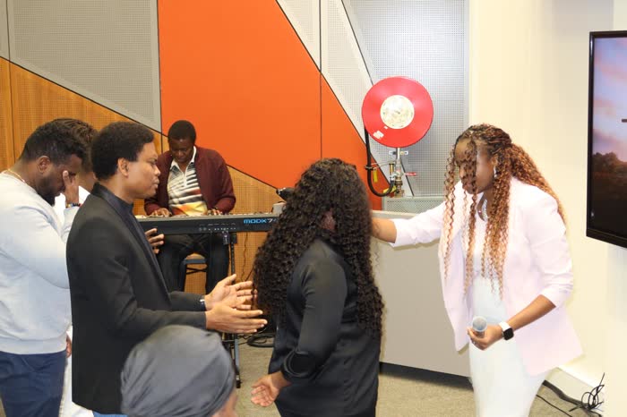 Dr. Imaobong Odutola praying with believers
